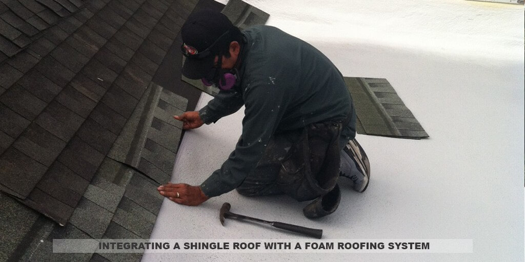 Armstrong Roofing - installation of spf roofing - worker on a white spf roof installing shingles on a sloped part of the roof