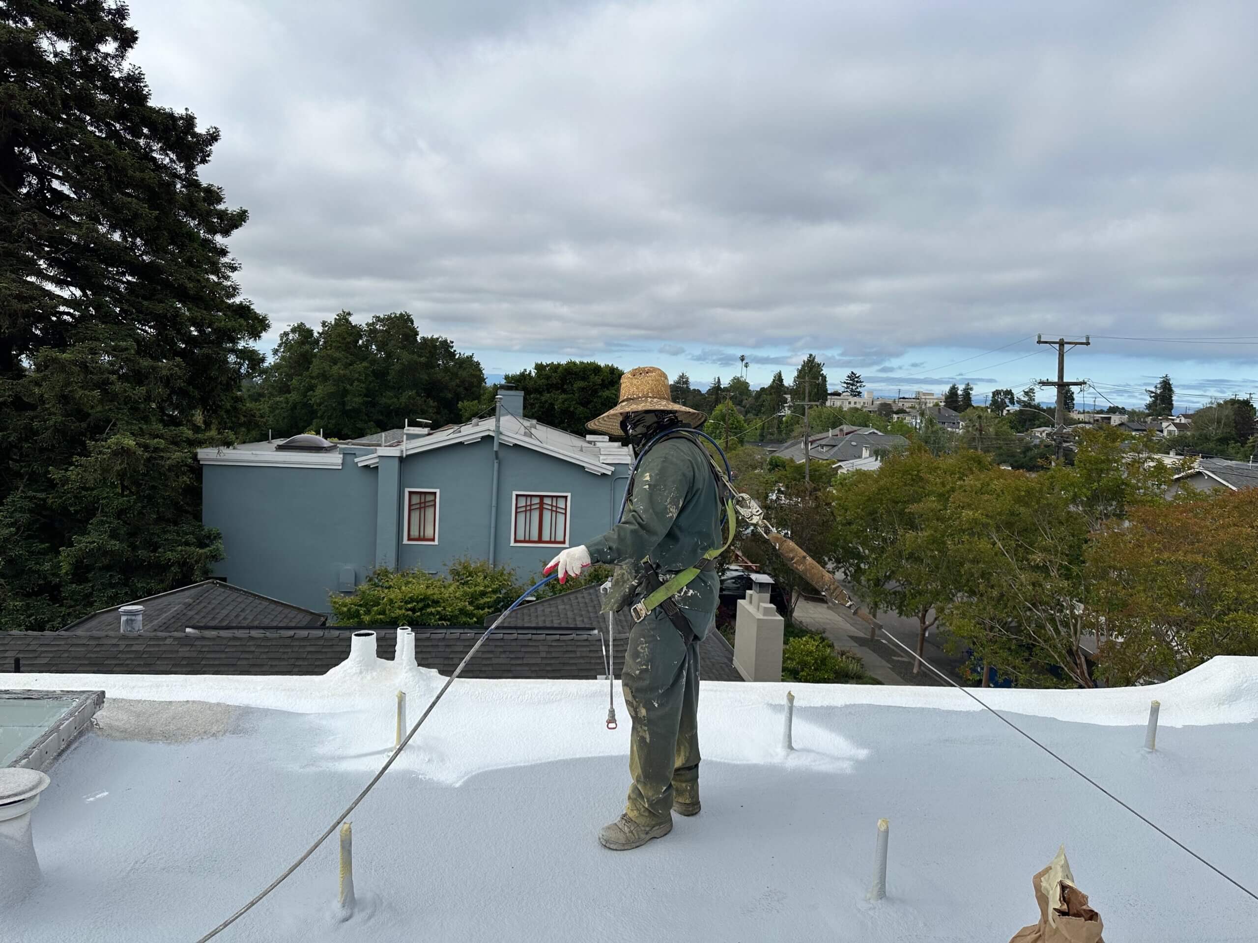 technician spraying foam roofing