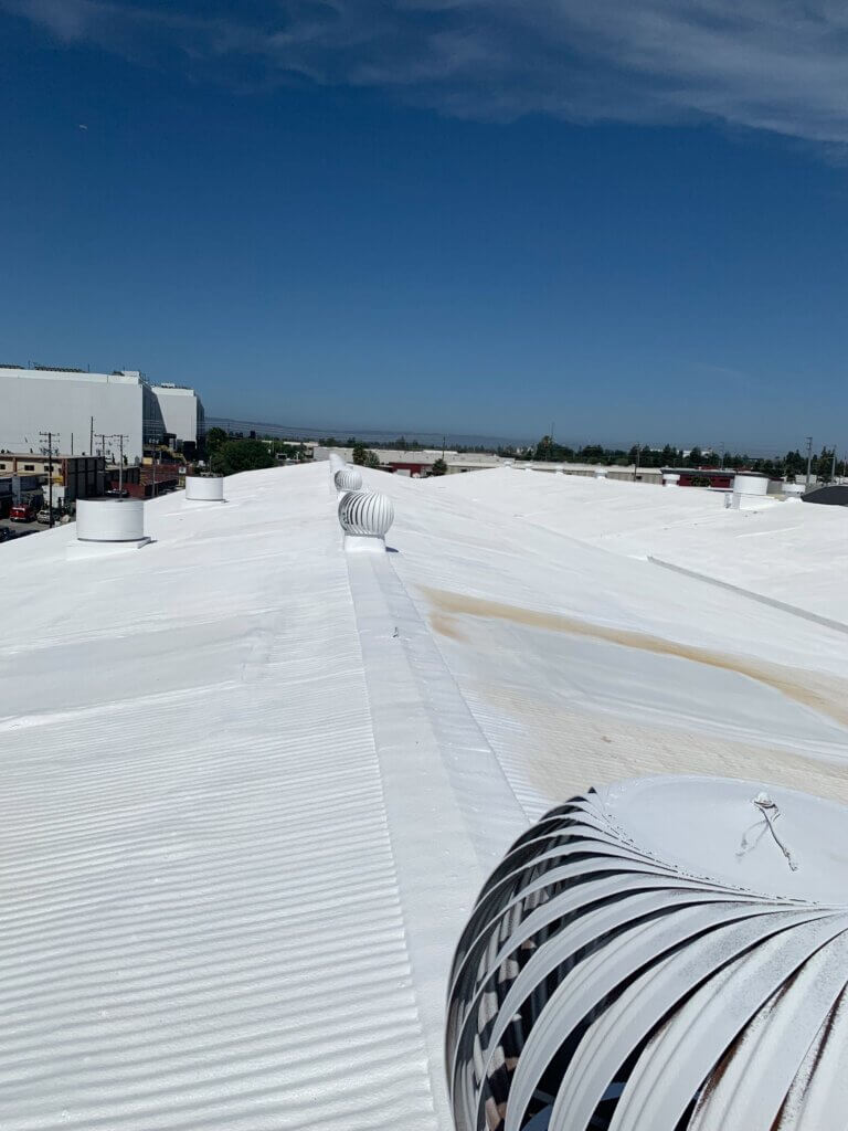 Camino Storage facility in Santa Clara showing the freshly coated white spray foam roof gleaming under the California sun