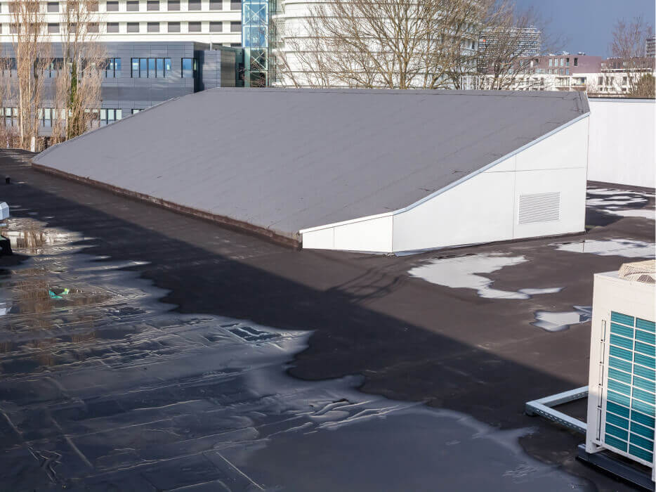 Tar and gravel roof with moisture issues due to ponding water