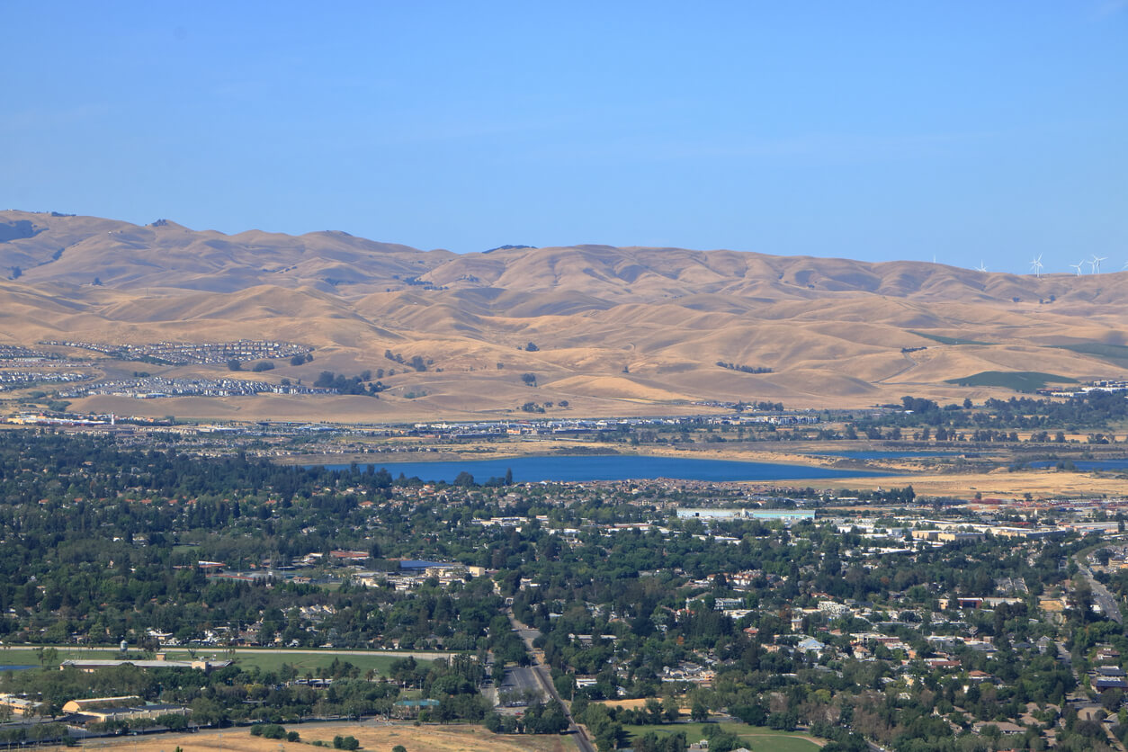 The blue waters of the lake sparkle in the dry landscape of summer near Livermore, Alameda County, CA